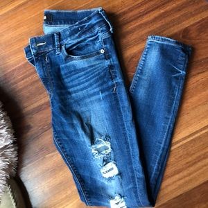 Express distresses mid rise skinny jeans